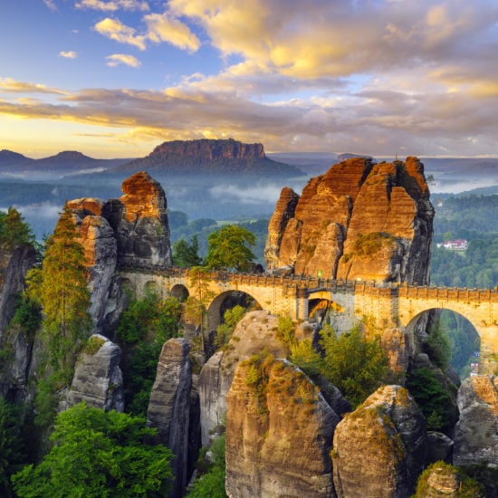 Het betoverende landschap in het Nationalpark Sächsische Schweiz met een brug, mist en rotsen