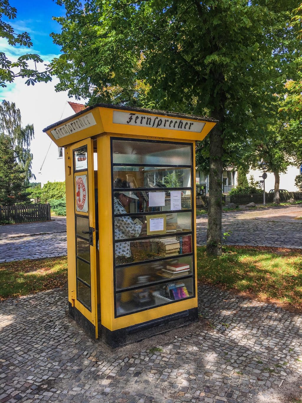 Een ouderwetse gele telefooncel in de Berlijnse wijk Alt-Lübars