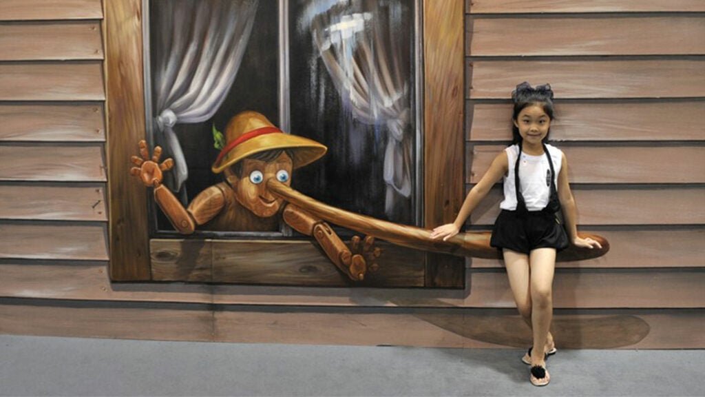 Een meisje zit op de neus van Pinocchio in Odysseum in Keulen